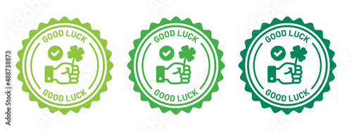 Good luck icon set. Hand holding green clover leaf icon on badge design.