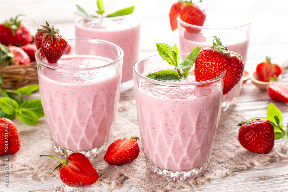 Strawberry milkshake in the glass jar. Smoothie and fresh strawberries. Healthy food and drink concept. Strawberry milkshake in the glass jar. Smoothie and fresh strawberries. Healthy food and drink concept.