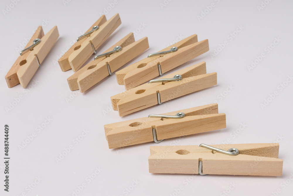 wooden clothespins lie in a corner on a white background with copy space wooden clothespins lie in a corner on a white background with copy space