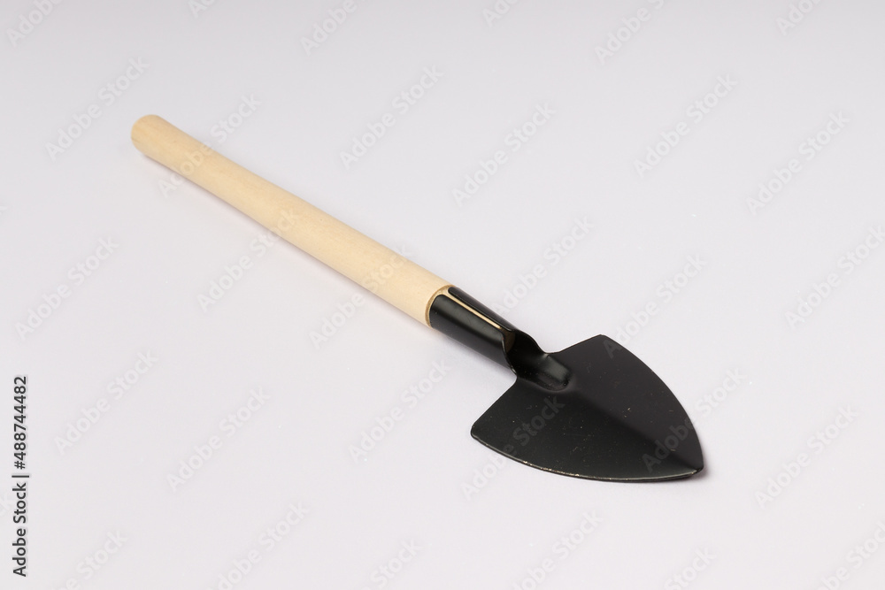 shovel with a wooden handle for indoor flowers on a white background