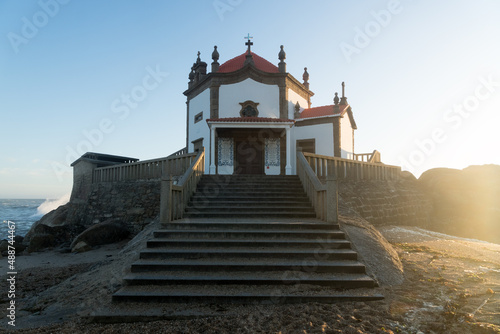 Capela do Senhor da Pedra or Lord of the rock chapel at sunset  Miramar  Portugal