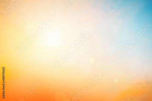 Relaxing outdoors vacation landscape concept: Abstract blurred sunlight beach colorful blurred bokeh background with retro effect autumn sunset sky have blue bright, white, and color orange calm.