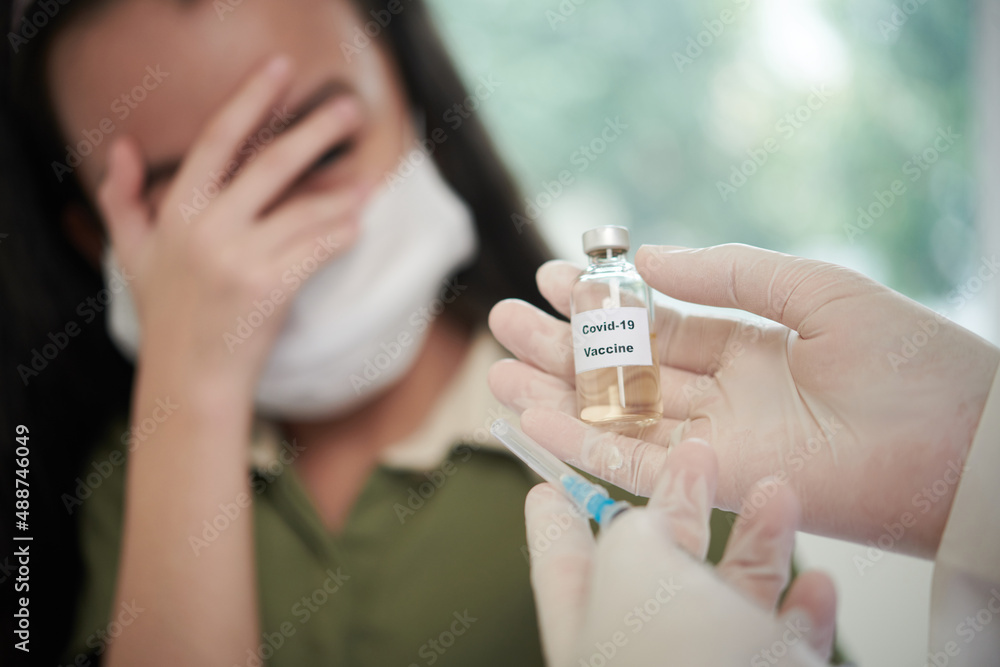 Close-up of doctor in protective gloves holding medicine from coronavirus and giving it to children at hospital Close-up of doctor in protective gloves holding medicine from coronavirus and giving it to children at hospital