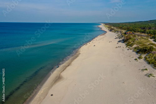 White sand beach. View to Baltic Sea Costline. Curonian Spit, Aerial view of the sea coast with waves. Travel and vacation concept.