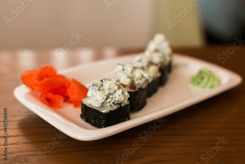 Traditional delicious fresh sushi roll set on a plate in restaurant. Sushi menu. Japanese kitchen, restaurant.