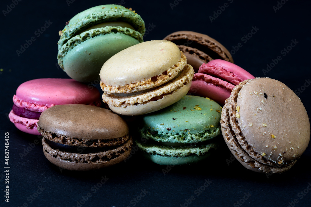 The Netherlands. January 2022. Close up of colorful macarons against a black background. The Netherlands. January 2022. Close up of colorful macarons against a black background.