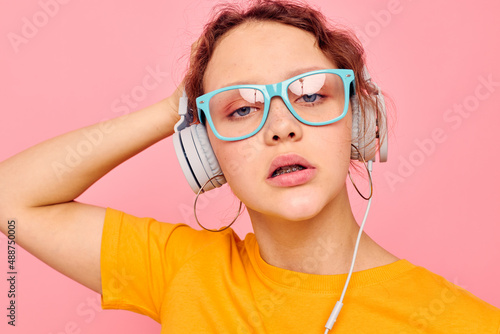 beautiful woman grimace headphones music entertainment technology pink background unaltered