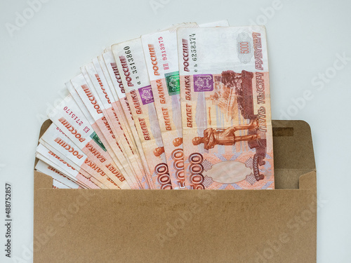 Money in envelope on white background. Cash in envelope. Russian roubles. RUB. Russian money in envelope. Savings. Bribery and corruption. Bribe in envelope. Russian money. Money laundering