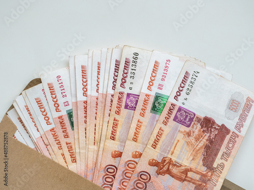Money in envelope on white background. Cash in envelope. Russian roubles. RUB. Russian money in envelope. Savings. Bribery and corruption. Bribe in envelope. Russian money. Money laundering