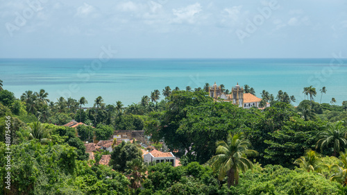 The Igreja Nossa Senhora Do Carmo church surrounded by water and trees photo