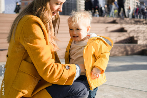 A mother is consoling her crying little son. They are outside on a beautiful sunny day. © Stock Rocket