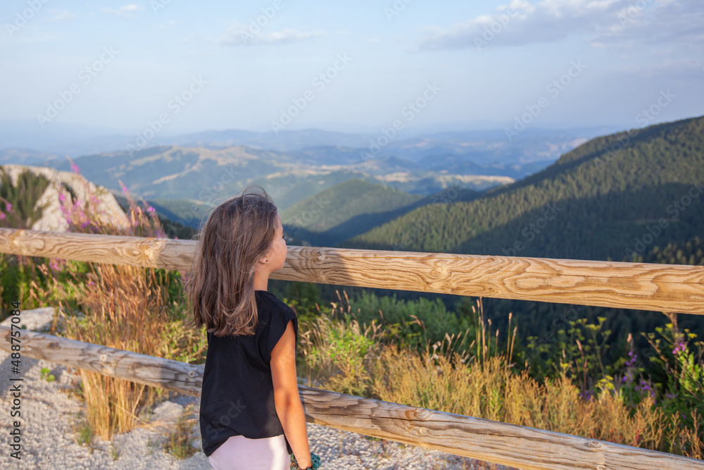 Little girl from viewpoint enjoy summer nature landscape .