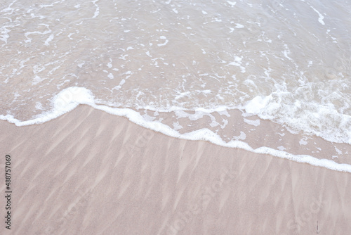 Seaside baltic sea coast view with small wave bubbles.