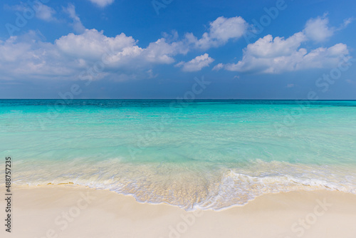 Sea sand sky, nature landscape concept. Tropical island shore, coast as beach scenery. Perfect waves on calm seaside horizon. Exotic Indian ocean lagoon, blue bright sky, surf waves, relax vacation