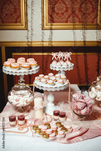 Wallpaper Mural cupcakes with pink cream and decorated with golden pastry beads on a white tray Torontodigital.ca