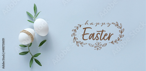 Quadro su tela Eggs and text HAPPY EASTER on light background