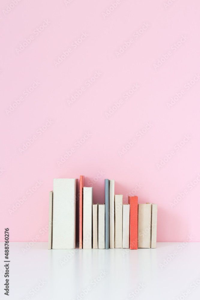 Obraz premium Old Books against pink wall.