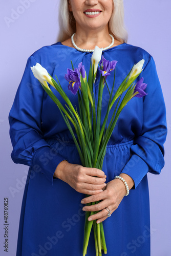 Mature woman with bouquet o...