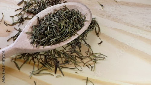 Wooden spoon with rosemary seasoning.