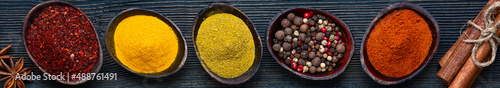 Wooden table of colorful spices. Dark.background.