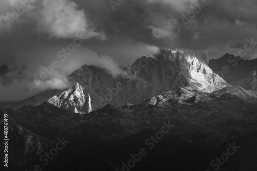 dramatic landscape of sharp mountain peaks covered by clouds