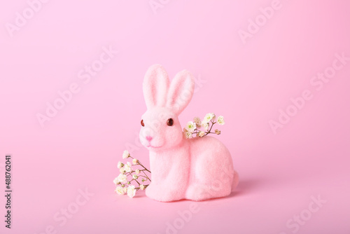 Beautiful Easter bunny and flowers on pink background