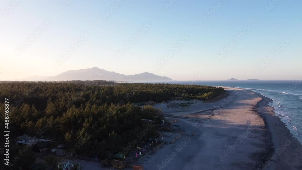 Drone shot of seashore with trees and mountain Drone shot of seashore with trees and mountain