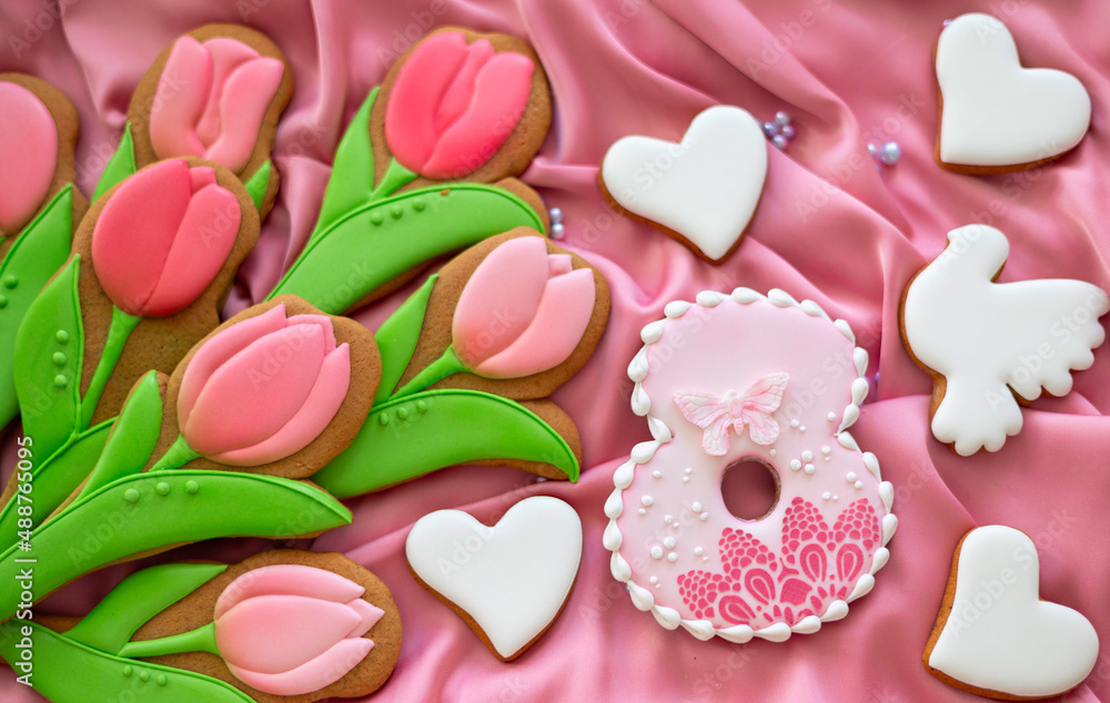 background banner greeting card for international women day with eight number, tulips and pigeon shape gingerbread cookies on pink silk fabric background background banner greeting card for international women day with eight number, tulips and pigeon shape gingerbread cookies on pink silk fabric background