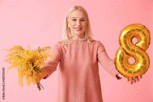 Smiling mature woman holdin...