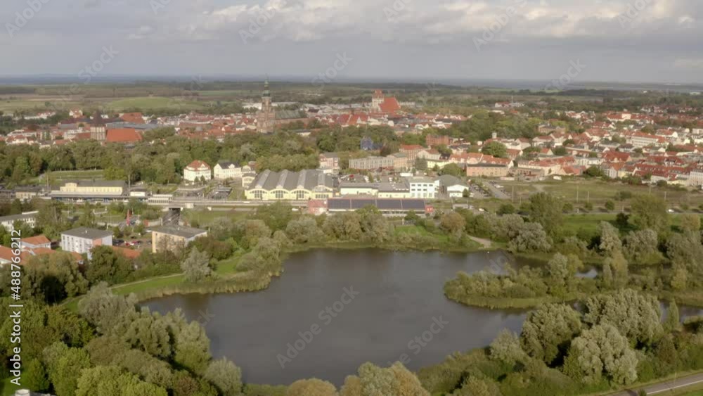 Aerial drone flight over the city of Greifswald during sunset with warm summer light Aerial drone flight over the city of Greifswald during sunset with warm summer light
