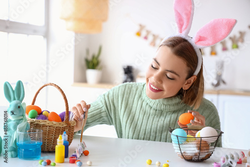 Photography Beautiful woman painting Easter eggs at home