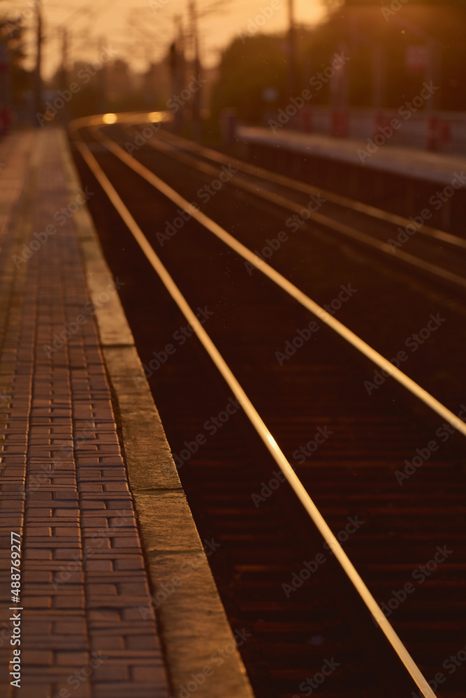 The railtrack go into the distance. Railway station at sunset The railtrack go into the distance. Railway station at sunset
