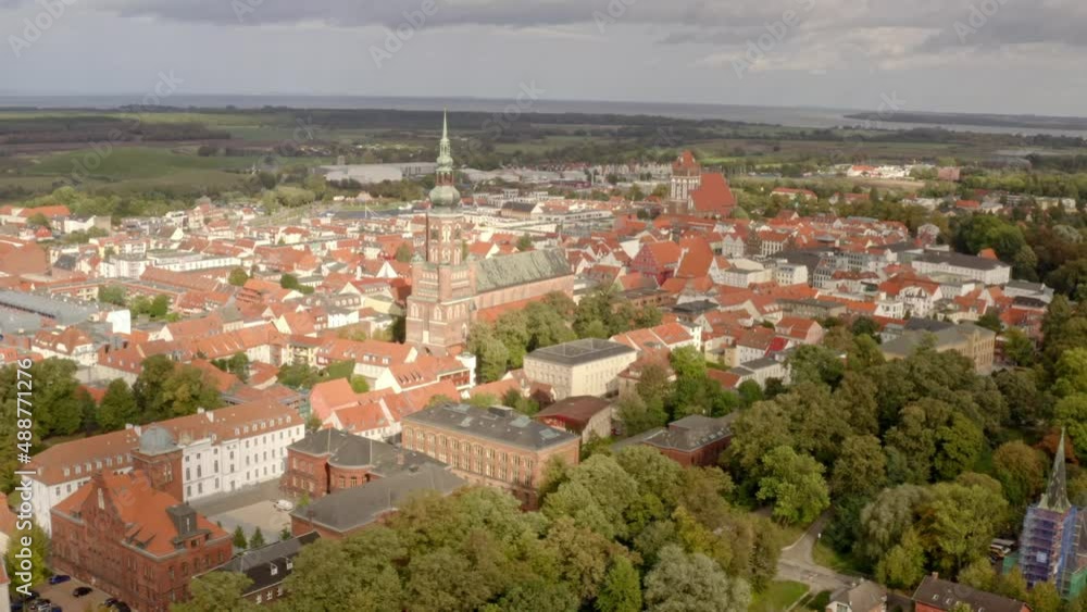Aerial drone flight over the city of Greifswald during sunset Aerial drone flight over the city of Greifswald during sunset