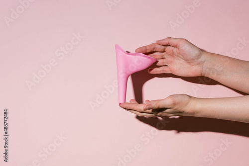 Fototapeta Pink silicone female urinal is a device for urinating in a public toilet