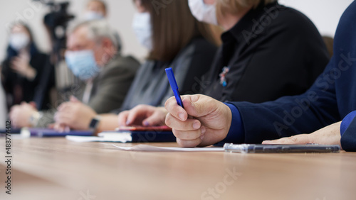 A man holds a fountain pen in his hands during a meeting or negotiations. Age official, lawyer or businessman. Retraining and the coronavirus pandemic. No face