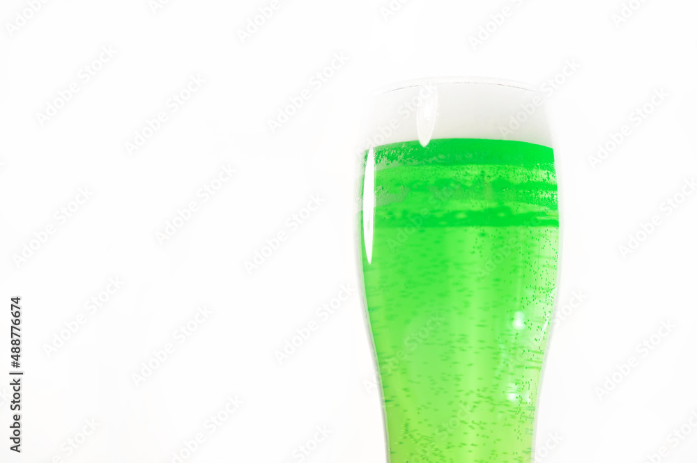 A pint of green beer for st patrick's day on a white background. Traditional Irish drink for a holiday A pint of green beer for st patrick's day on a white background. Traditional Irish drink for a holiday