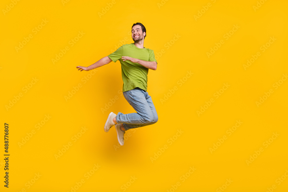 Full body profile side photo of young man jump up wondered look empty space isolated over yellow color background