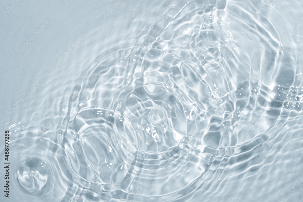Circles on water. Blue round shadows. Blurred background made with water and light in monochrome. Pureness and freshness concept. Circles on water. Blue round shadows. Blurred background made with water and light in monochrome. Pureness and freshness concept.