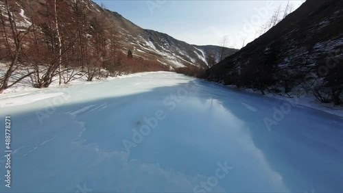 Flying on an FPV drone along a frozen river