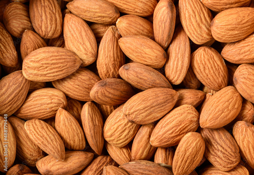 Background of big raw peeled almonds situated arbitrarily. Background of big raw peeled almonds situated arbitrarily.