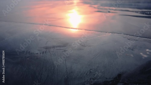 The setting sun is reflected in the ice of Lake Baikal