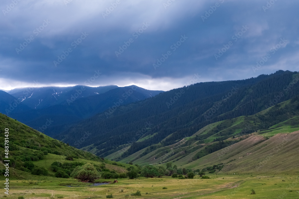 Beautiful mountains with heavy clouds. Thunderstorm, bad weather in the mountains concept. Gorge near Saty village.