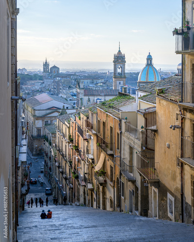 Fototapeta Naklejka Na Ścianę i Meble -  Vertical view of Caltagirone rooftops, cupolas and cathedral, from the famous Scala Santa Maria del Monte, a long public staircase in the hilltop medie