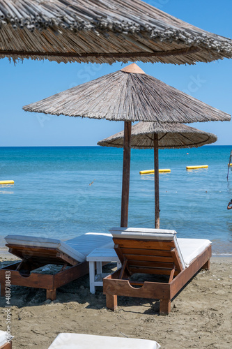 Beach unbrellas and chairs on sunny sandy beach Lady's mile in Akritori, Cyprus