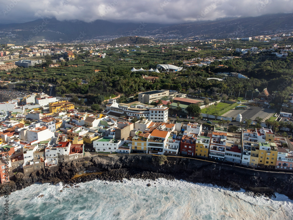 Aerial view on colorful houses and black lava rocks in small village Punta Brava near Puerto de la Cruz, Tenerife, Canary islands
