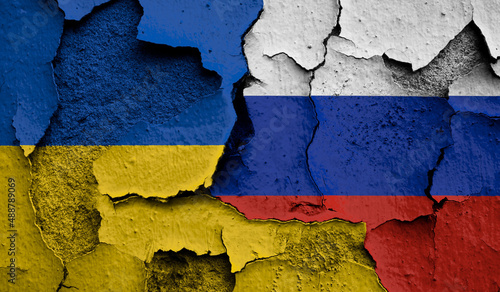 Flag of Ukraine and  Russia on old grunge wall in background  photo