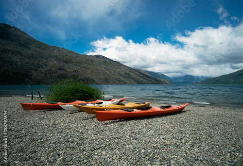 Kayaks on the lake. Stunning view of the coast in nature. Relaxing vacations, travel, adventure exploration. photo
