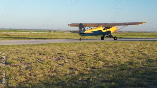 Small high wing aircraft taxis at rural airport