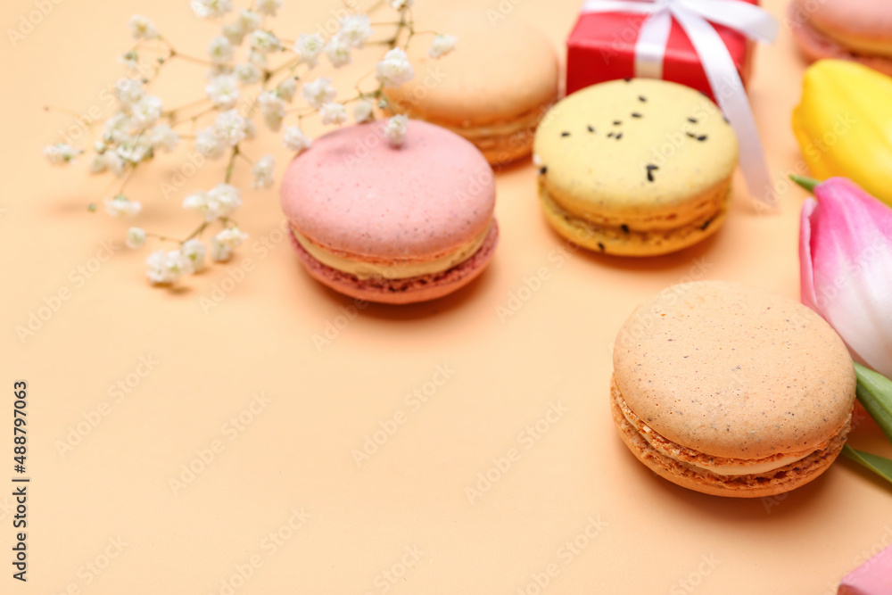 Sweet macaroons and flowers on color background, closeup Sweet macaroons and flowers on color background, closeup