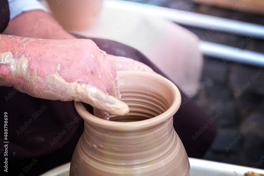 Potter's hands . ceramic ware of clay. pottery